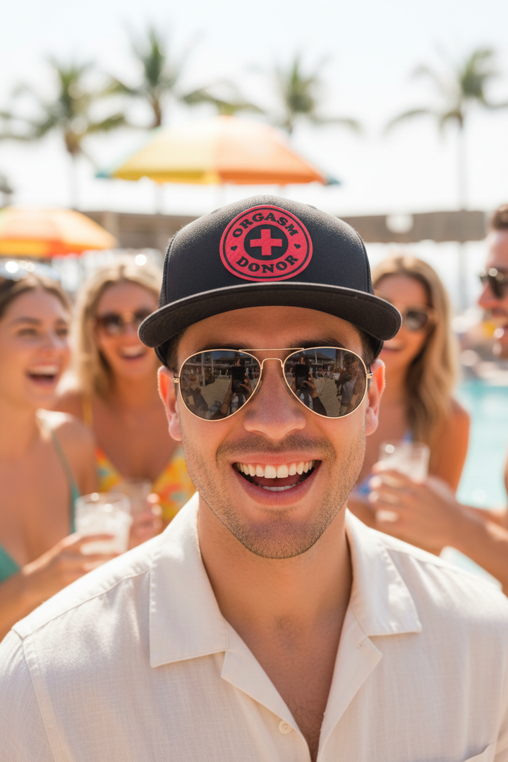 Casual guy with sunglasses wearing Orgasm Donor hat outdoors